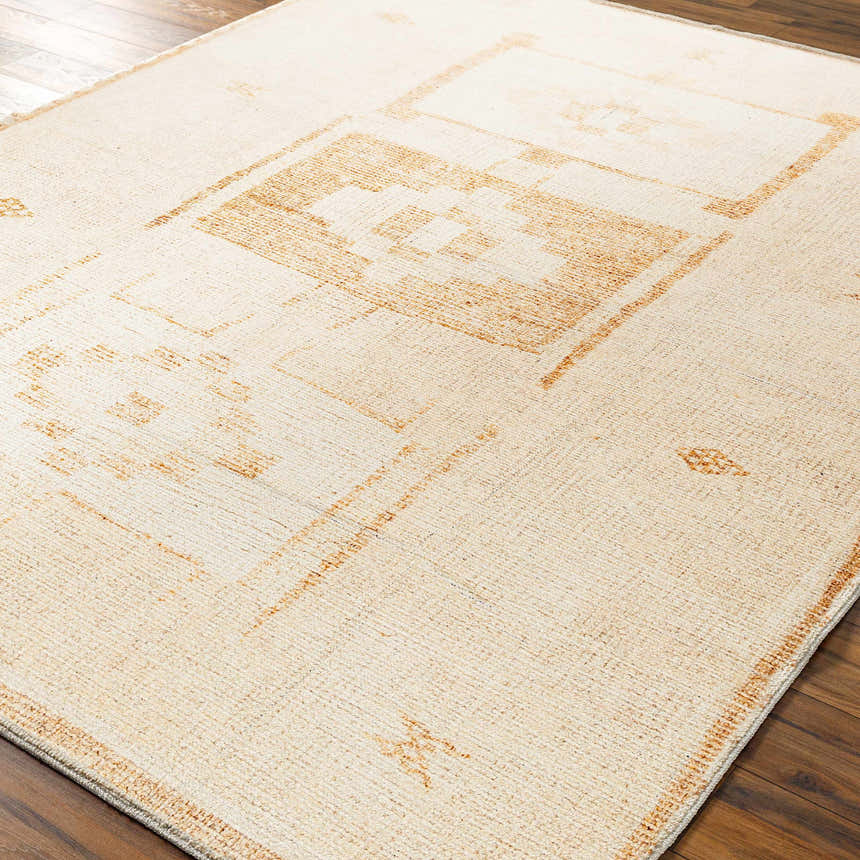 Close-up of Solana Medallion Peach rug by Livabliss x Becki Owens. Beige rug with a geometric peach medallion pattern. Corner