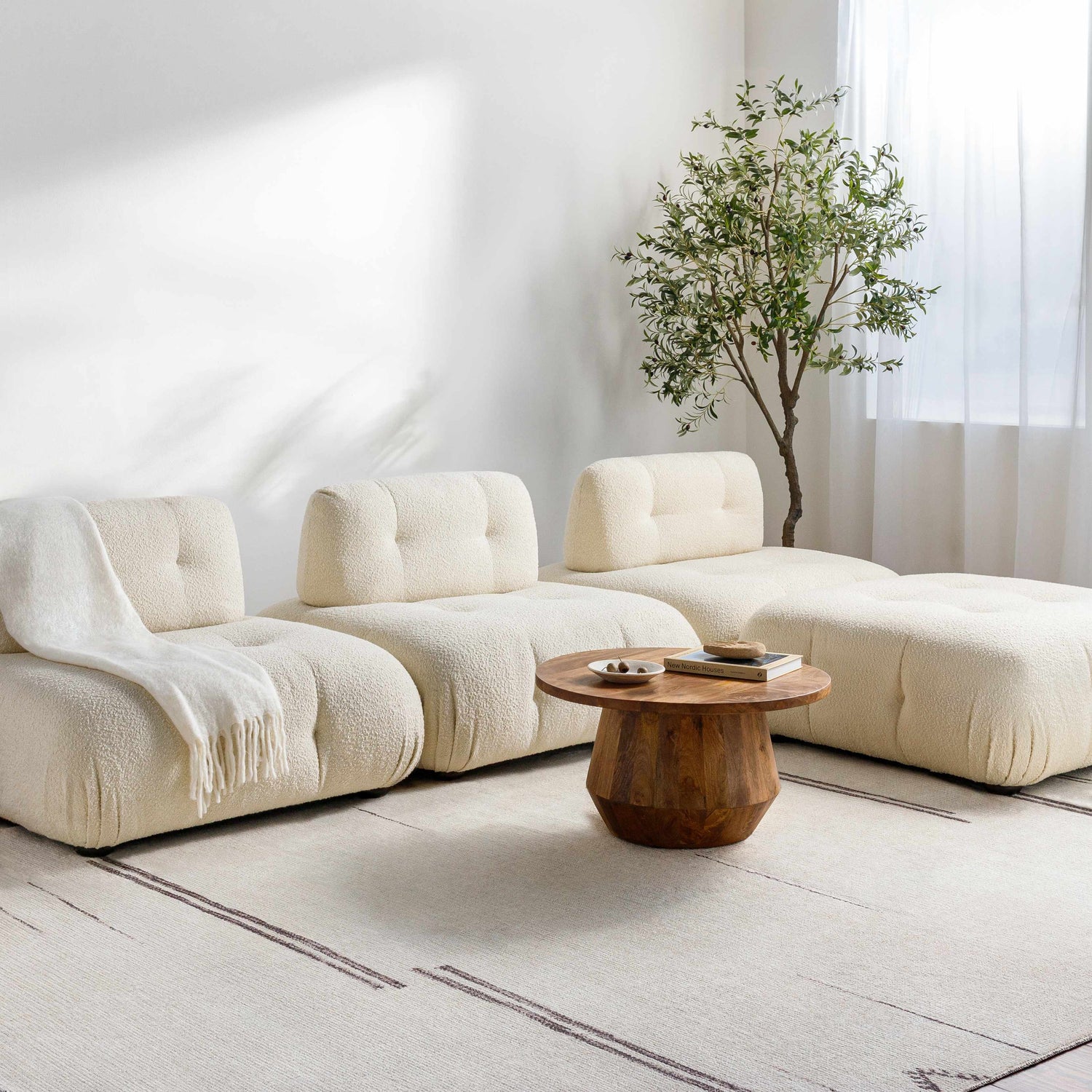Living room with modular seating on Rivin Beige Rug by Becki Owens x Livabliss. Farmhouse style with wood table and tree. Roomscene-Rectangle