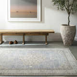 Entryway with wood bench, potted tree, and Lila Medallion Denim Area Rug in charcoal, dark gray, and light gray. Roomscene-Rectangle