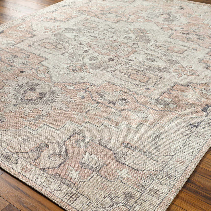 Close-up of the Elle Medallion Taupe Area Rug showing its beige, light brown, and dark gray traditional pattern. Corner