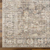 Close-up of the Marlene Medallion Brown Area Rug. Beige, brown, and black farmhouse-style rug with a traditional medallion pattern. Corner