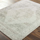 Close-up of the Luca Medallion Olive Area Rug showing its beige, bone, and olive traditional medallion pattern. Corner