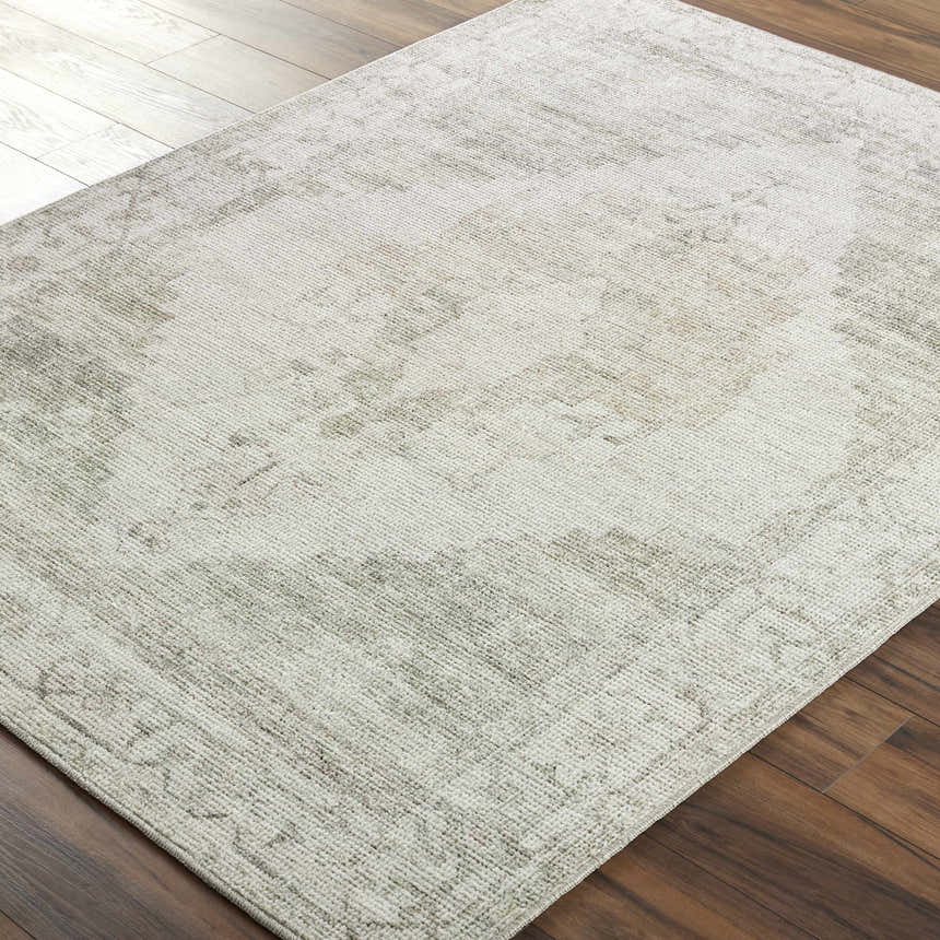 Close-up of the Luca Medallion Olive Area Rug showing its beige, bone, and olive traditional medallion pattern. Corner