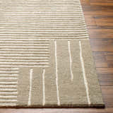 Close-up of the hand-tufted Akuji Area Rug. Contemporary design with linear pattern in light peach and medium gray wool. Front