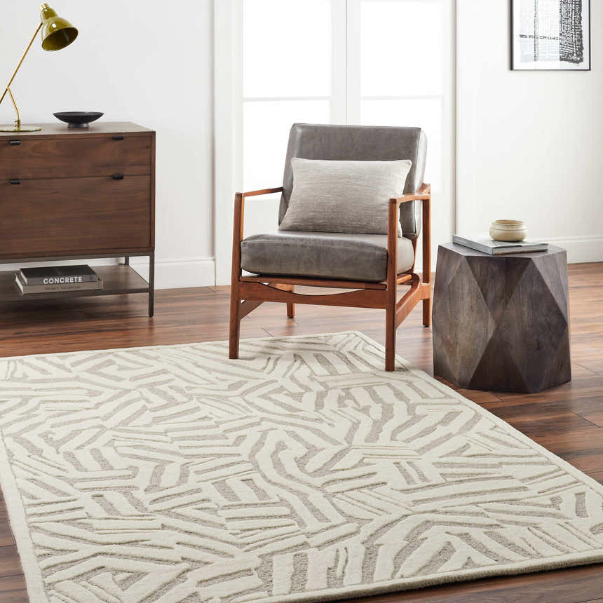Living room scene with Avian Cream Wool Area Rug, gray chair, wood side table, and dresser. Roomscene-Rectangle