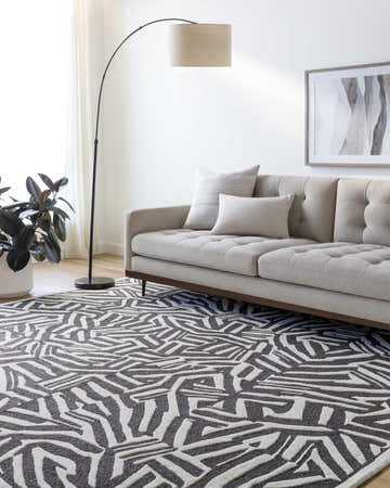 Living room with a cream sofa and Avian Black Wool Area Rug. Roomscene-Rectangle
