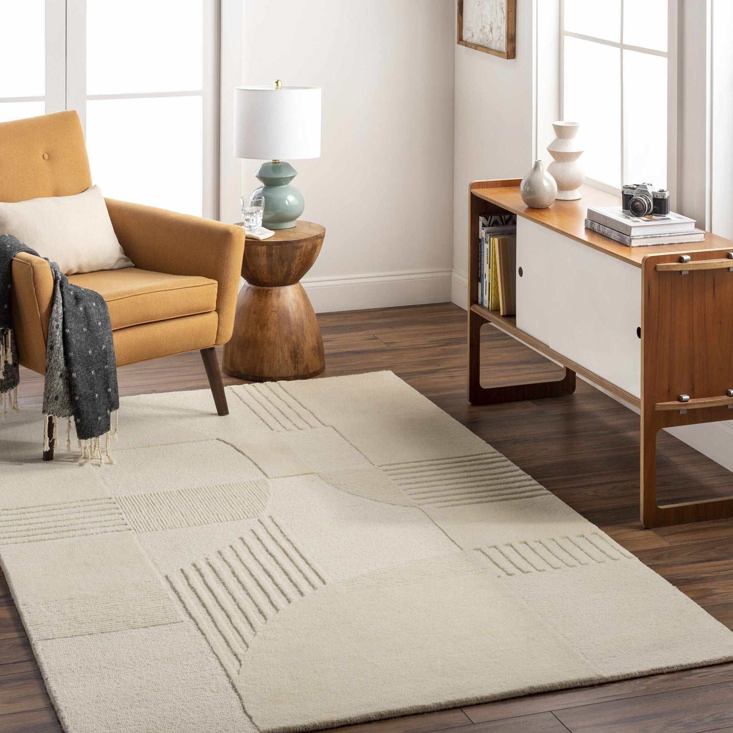 Living room scene with a lambswool Denis Area Rug, mustard chair, and mid-century modern cabinet. Roomscene-Rectangle