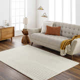 Living room scene with a Whan Off White Area Rug, beige sofa, wood furniture, and neutral decor. Roomscene-Rectangle