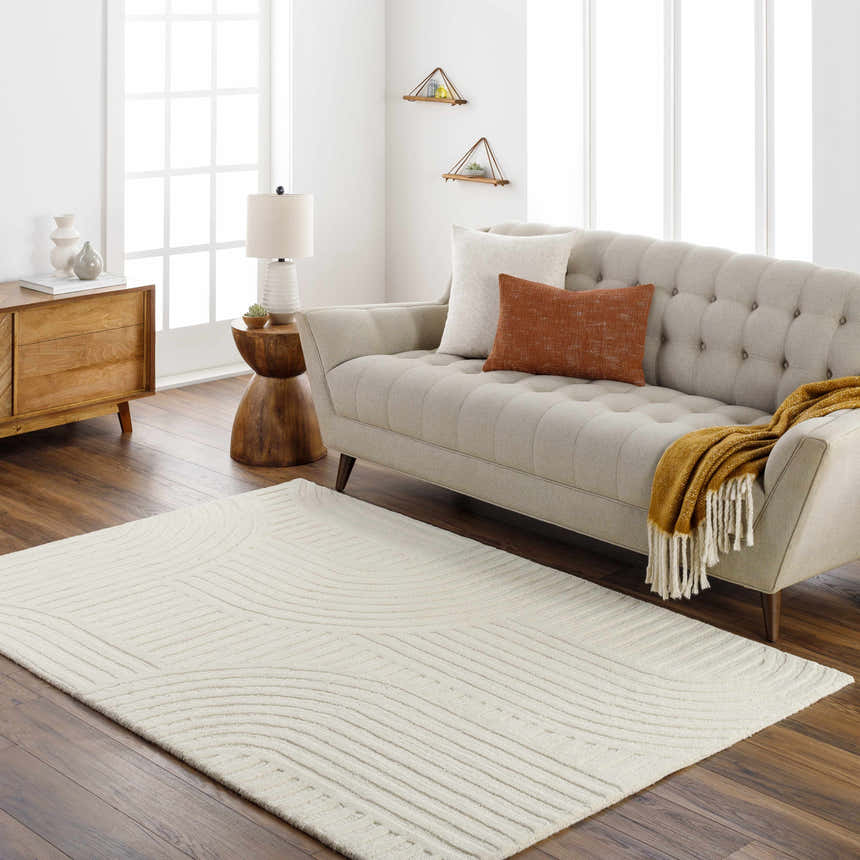 Living room scene with a Whan Off White Area Rug, beige sofa, wood furniture, and neutral decor. Roomscene-Rectangle
