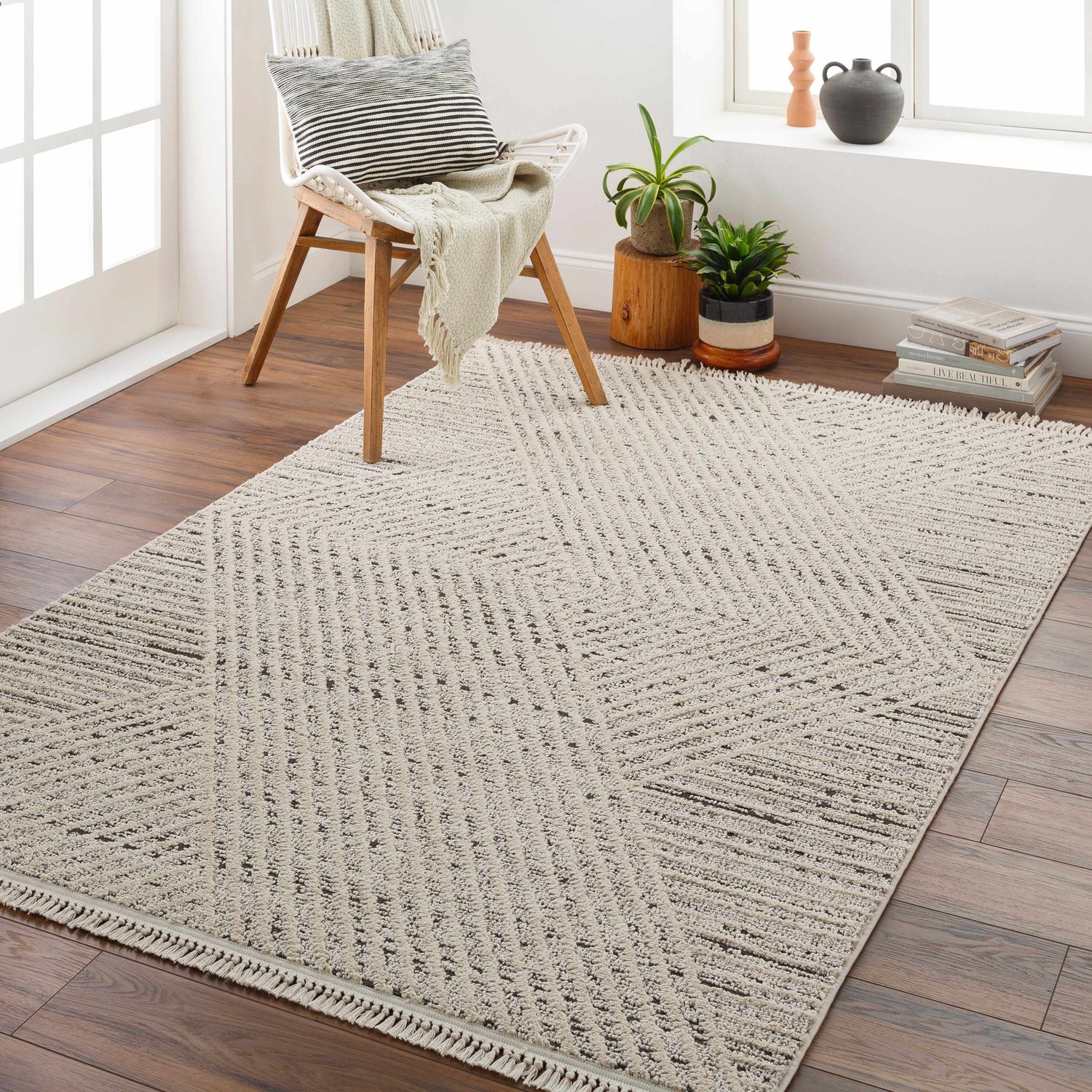 Bright entryway with a bone Brita Area Rug, wood floors, chair, and plants by the window. Roomscene-Rectangle