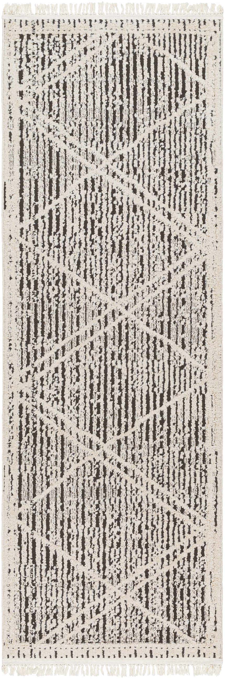 Close-up of the Luuk Area Rug. Brown and ivory rug with a geometric pattern and fringed edges. Design-Runner-2773