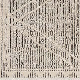 Close-up of Luuk Area Rug. Ivory rug with a dark brown geometric pattern and textured pile. Swatch
