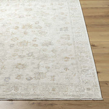 Close-up of the Sashi Ivory Luxe Area Rug showing its farmhouse style floral pattern and soft pale pink, gray, and blue colors. Front