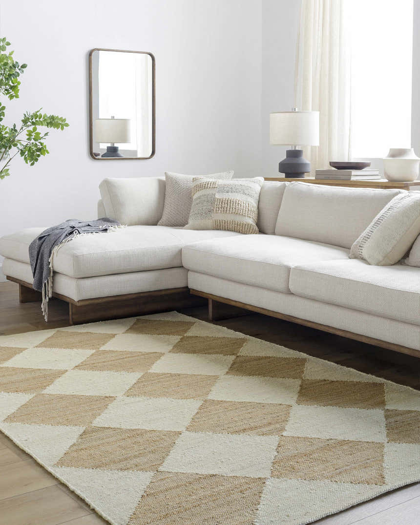 Living room scene with a beige sectional sofa and the Sondo Beige Area Rug with a diamond pattern. Roomscene-Rectangle