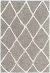 Close-up of the Faye Area Rug, featuring a charcoal shag texture and off-white geometric diamond pattern. Design-Rectangle-537
