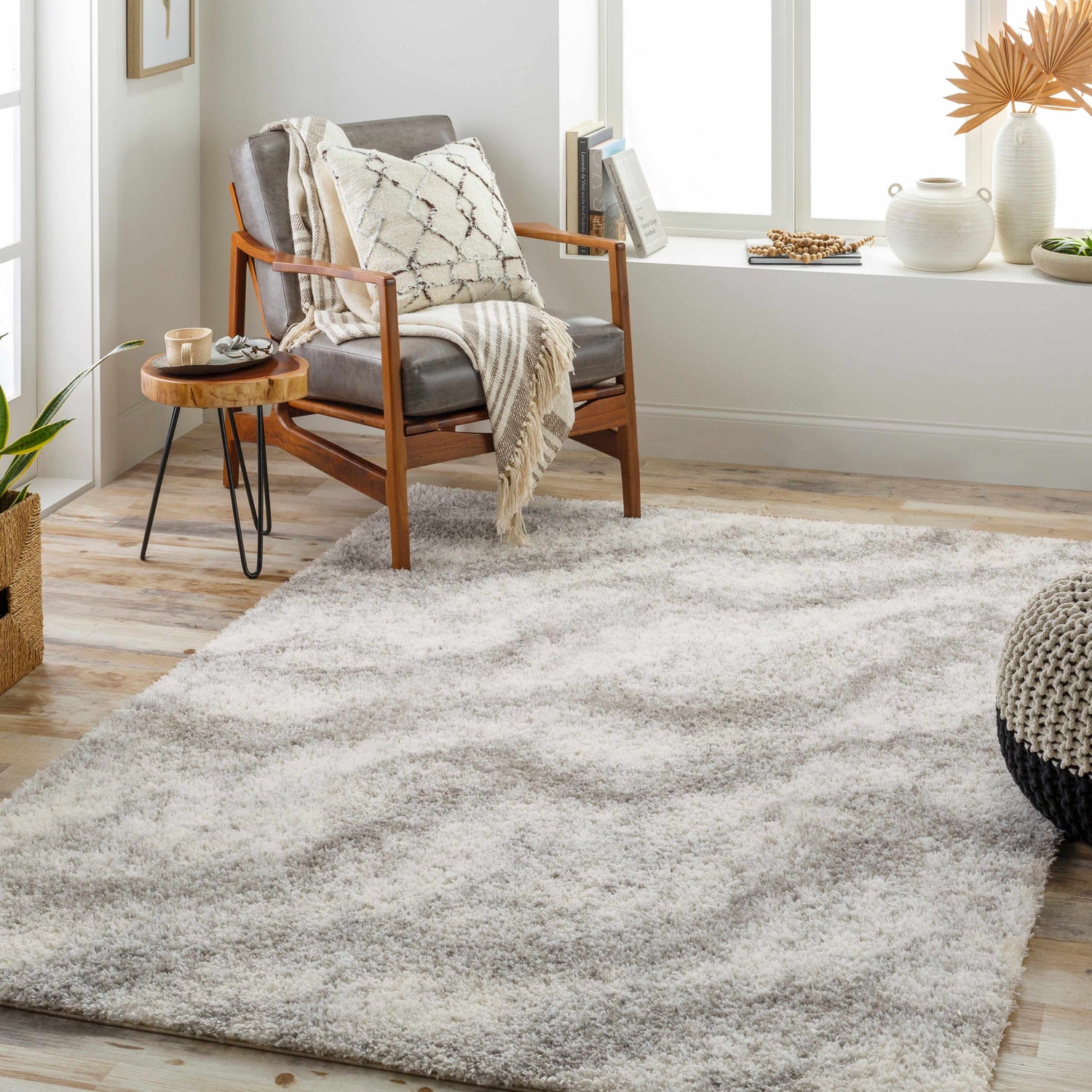 Cozy room scene with a bone and gray Giah Area Rug, leather chair, and wood accents. Roomscene-Rectangle