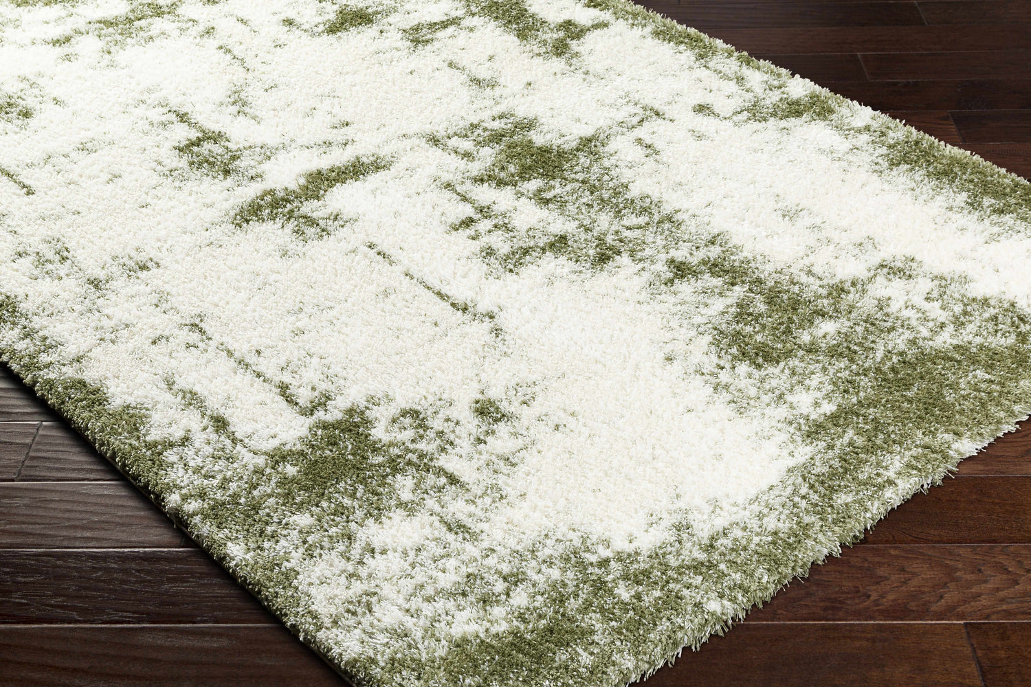 Close up of the shag Jioni Area Rug. Beige and bone colors with a soft, plush texture. Contemporary style. Corner