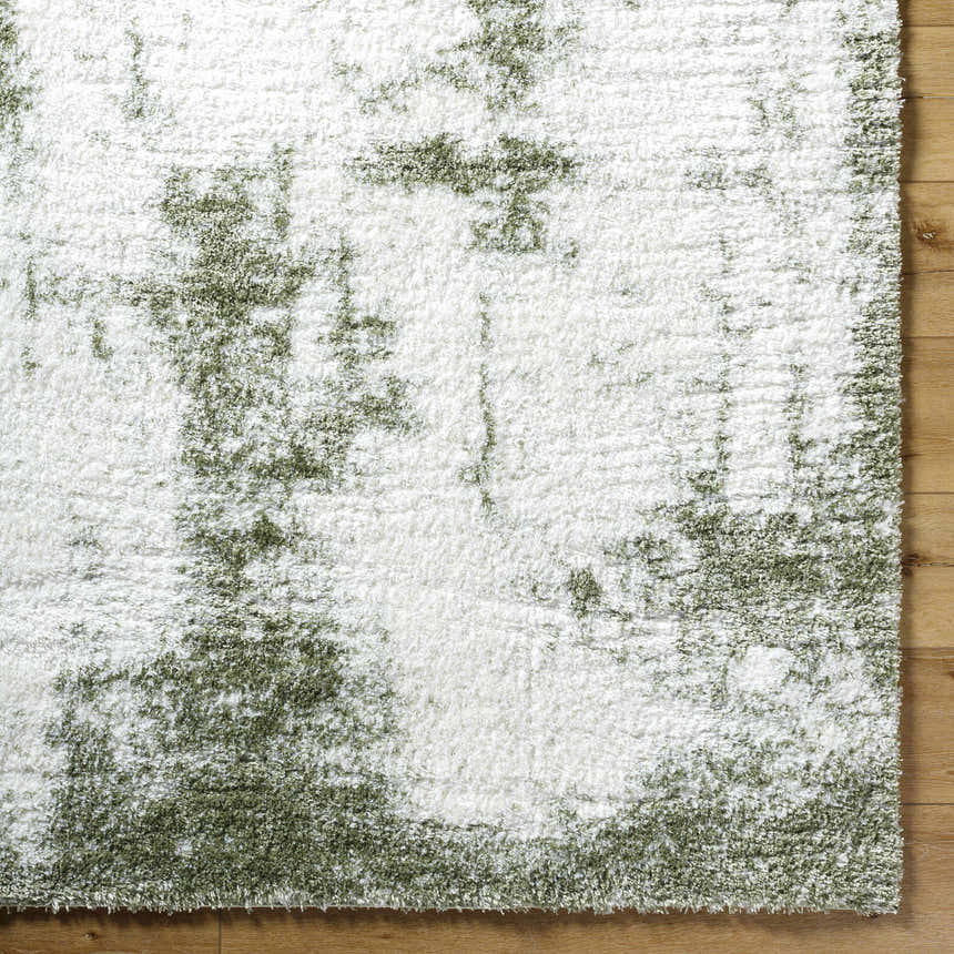 Close up of the shag Jioni Area Rug. Beige and bone rug with a soft, textured pile. Corner