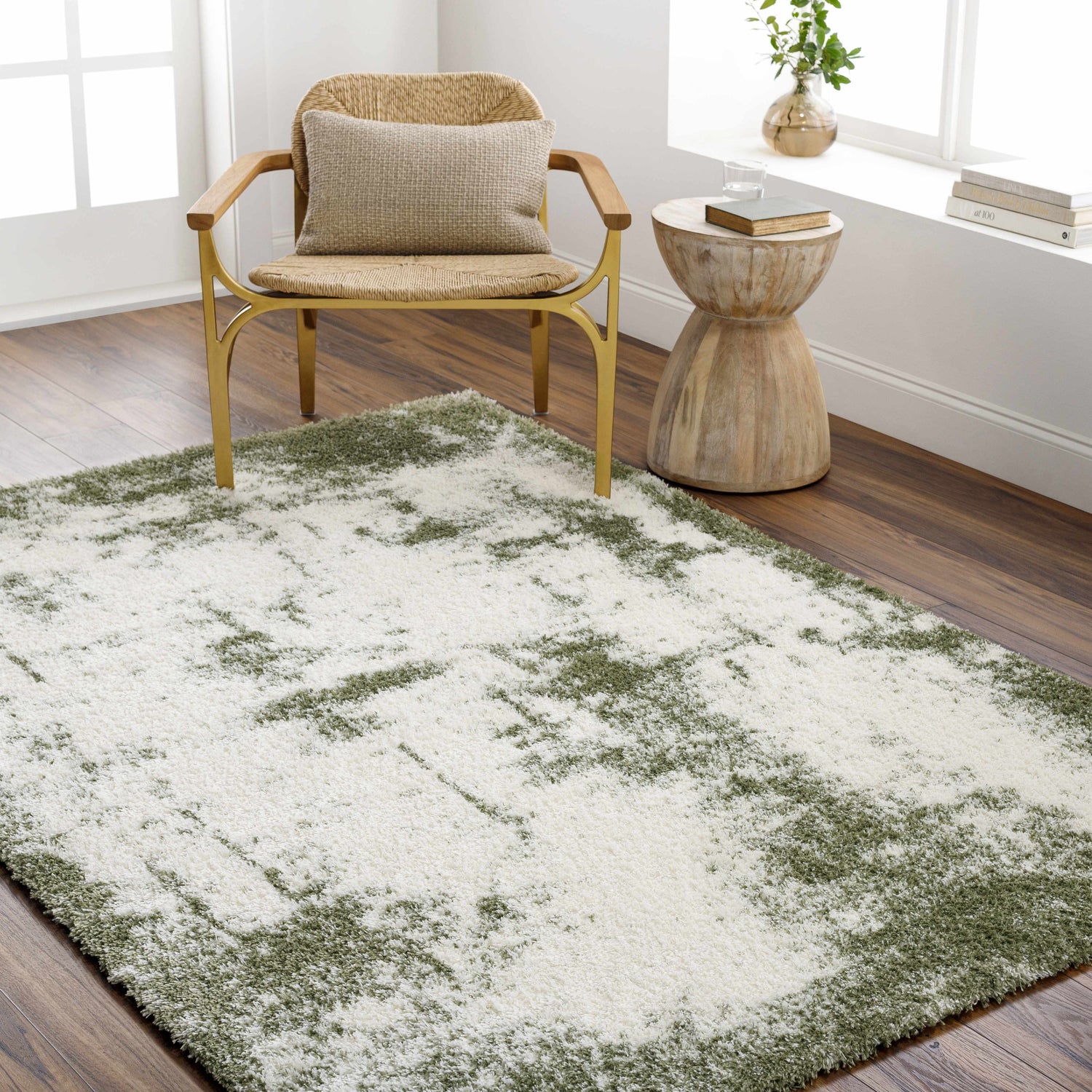 Living room scene with a beige and bone Jioni Area Rug, woven chair, and wood side table. Roomscene-Rectangle