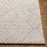 Close up of the Mura Cream Area Rug showing its shag texture and geometric pattern. Front