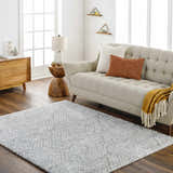 Living room scene with a beige sofa and the gray geometric Mura Area Rug on a wood floor. Roomscene-Rectangle