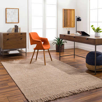 Home office with a Desma Tan Area Rug, wood desk, orange chair, and dark brown wood floors. Roomscene-Rectangle