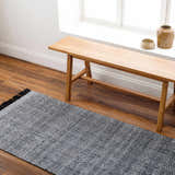 Entryway scene with a light wood bench and Dark Gray Anane Area Rug on wood floors. Roomscene-Runner