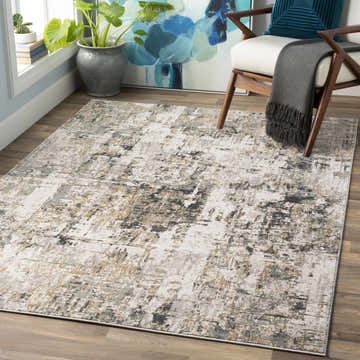 Living room scene with a Schaefferstown Area Rug in charcoal, gray, and beige. Modern chair and blue floral art. Roomscene-Rectangle