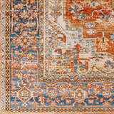 Close-up of the Basim Area Rug showing its traditional bone, charcoal, copper, and blue floral pattern. Swatch