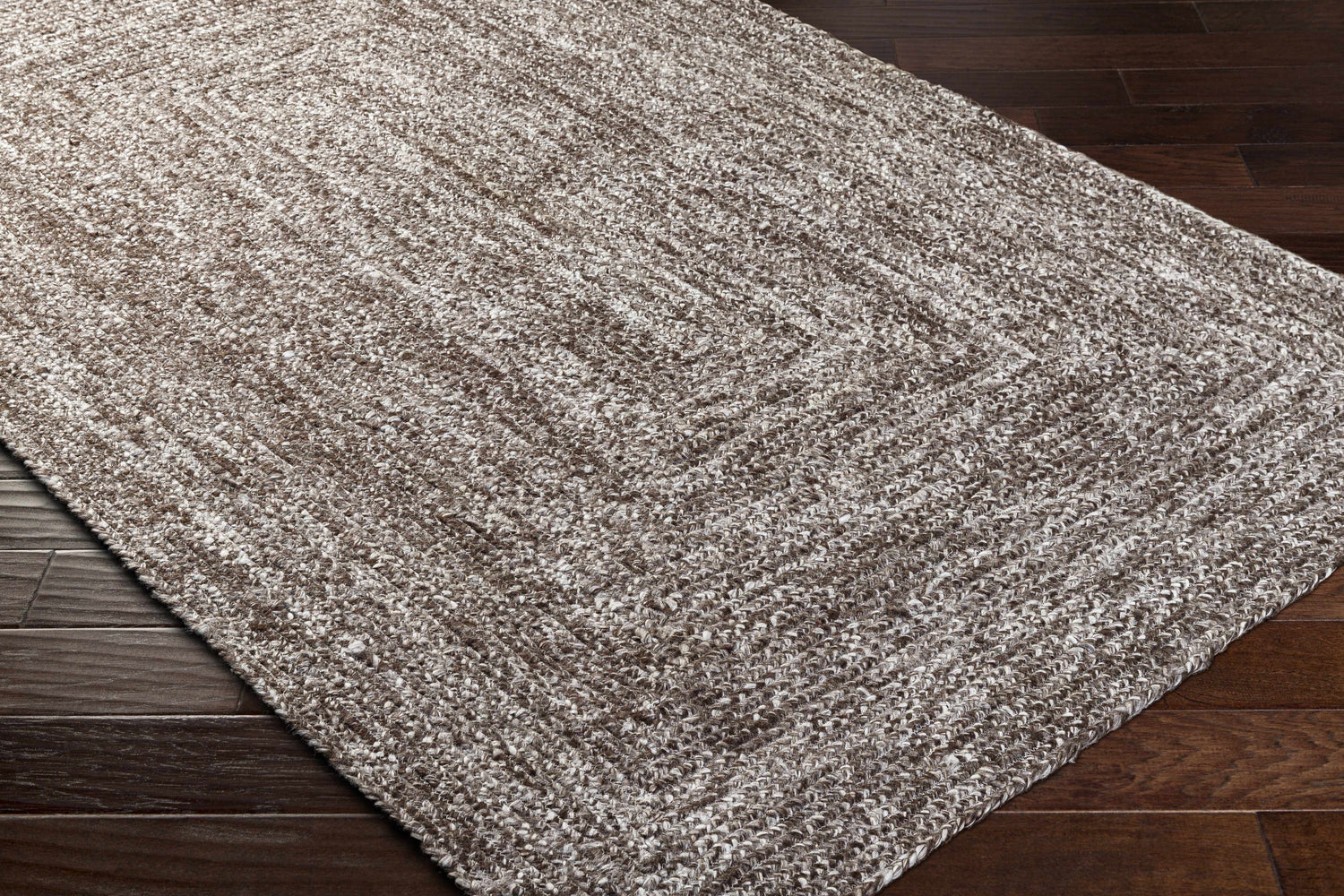 Close-up of the hand woven Kenyi Gray Area Rug showing its textured, transitional design and neutral colors. Corner