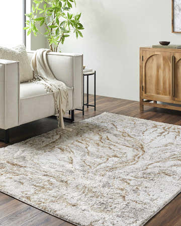 Living room scene with a light silver and warm gray Syler Area Rug, sofa, and wooden cabinet. Roomscene-Rectangle