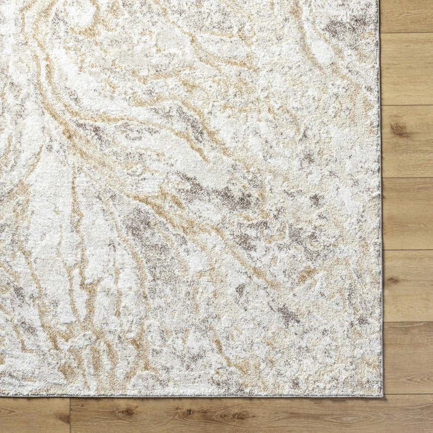 Close-up of the Syler Area Rug showing its light silver and warm gray abstract pattern and soft, textured pile. Corner