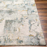Close-up of the Adlai Textured Rug showing the off-white, blue, gray, and mustard colors and textured design. Front