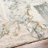 Close-up of the Adlai Textured Rug. Features a contemporary design with dusty sage, ink blue, and mustard accents. Texture