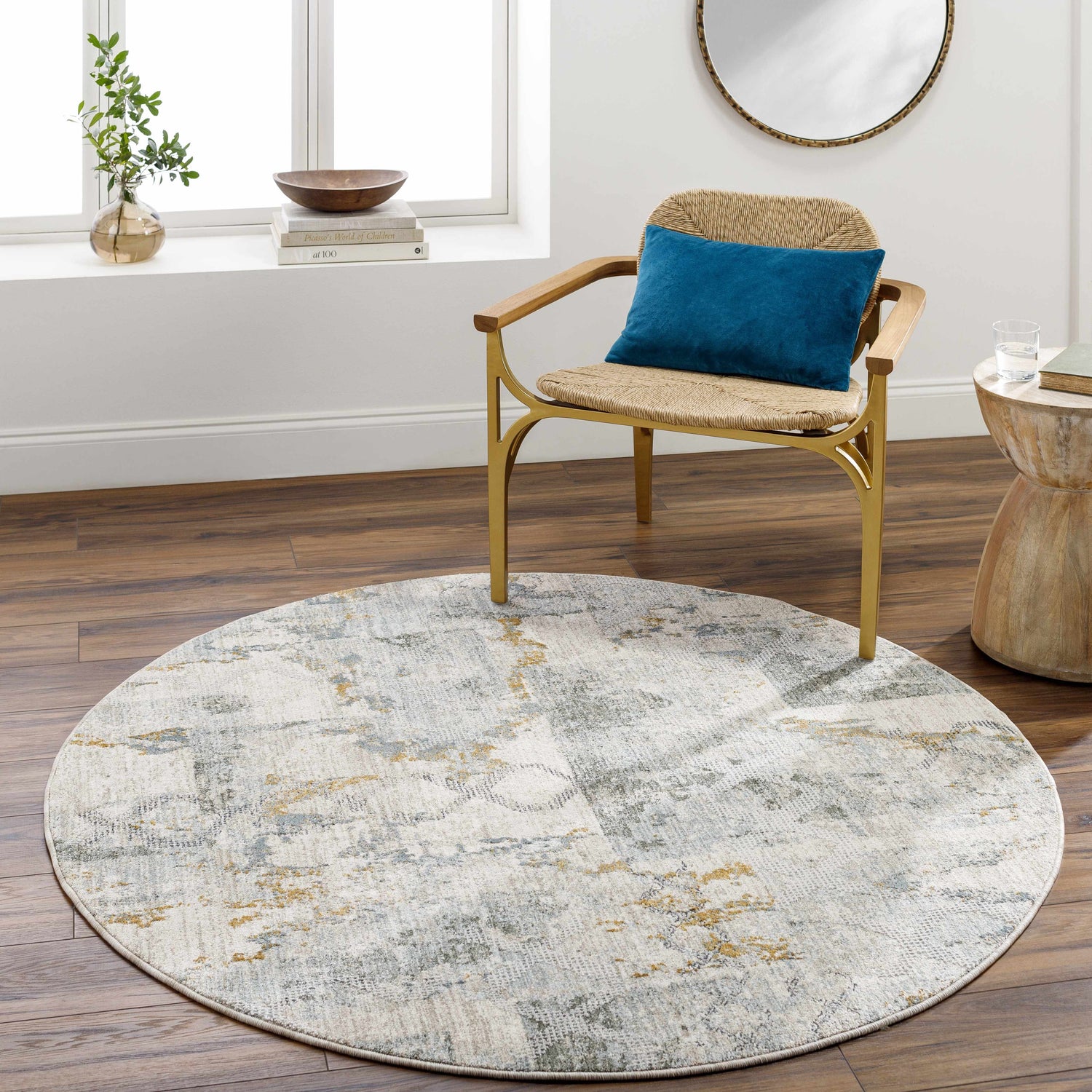 Living room scene with round Adlai Textured Rug in light gray, blue, and mustard colors. Roomscene-Round