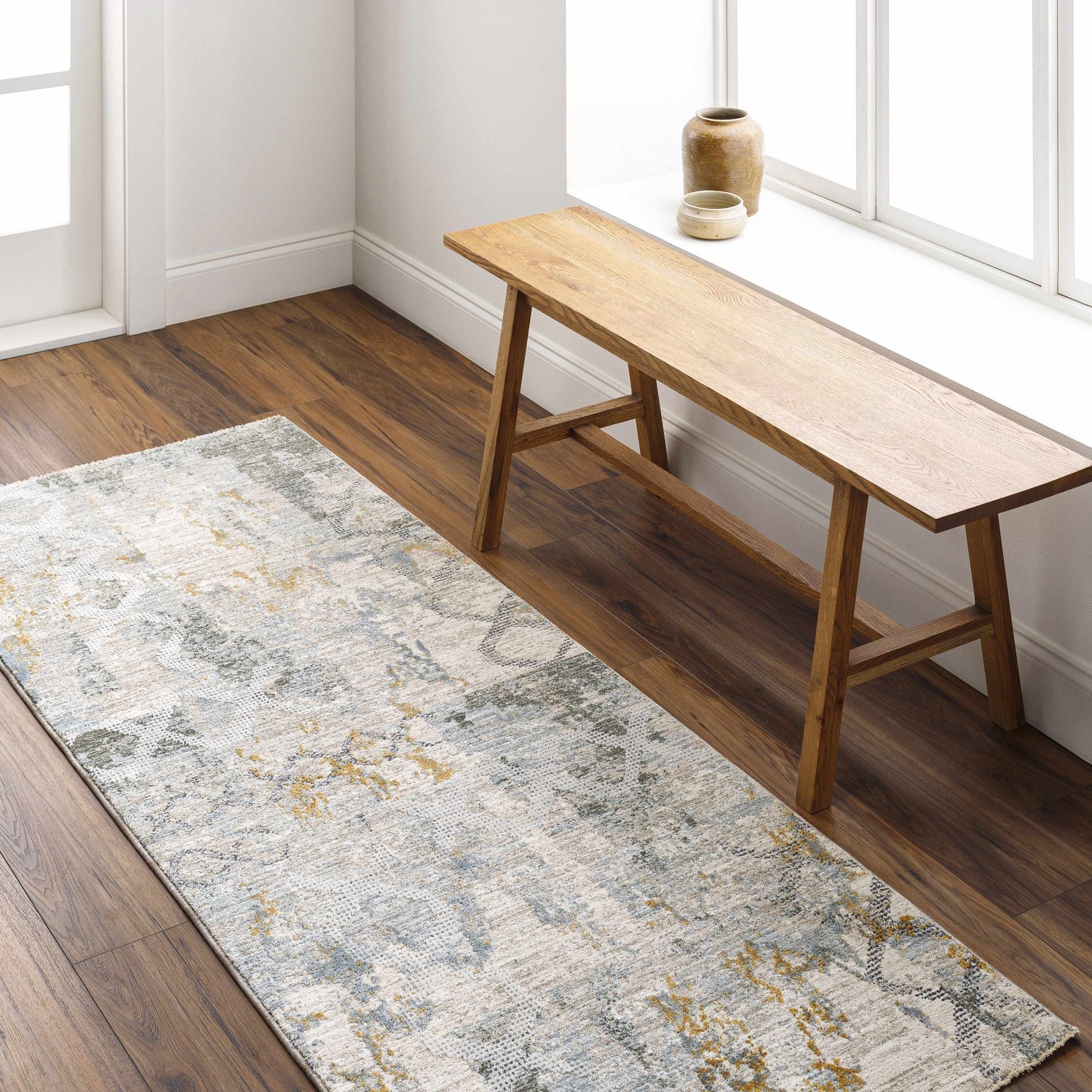 Entryway with wood bench and Adlai Textured Rug. Abstract pattern in dusty sage, blue, mustard, and off white. Roomscene-Runner
