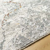 Close up of the Asena Textured Rug with Fringes. Features caramel, gray, and brown abstract pattern. Texture