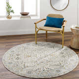 Living room scene with a round Aviva Off-White Textured Rug, woven chair, and wood accents. Warm, inviting, and stylish. Roomscene-Round