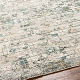 Close-up of the Chaka Textured Rug. Features a contemporary design with dusty sage, ink blue, and mustard accents. Texture