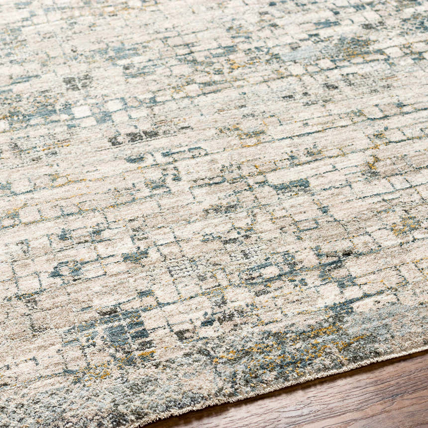 Close-up of the Chaka Textured Rug. Features a contemporary design with dusty sage, ink blue, and mustard accents. Texture