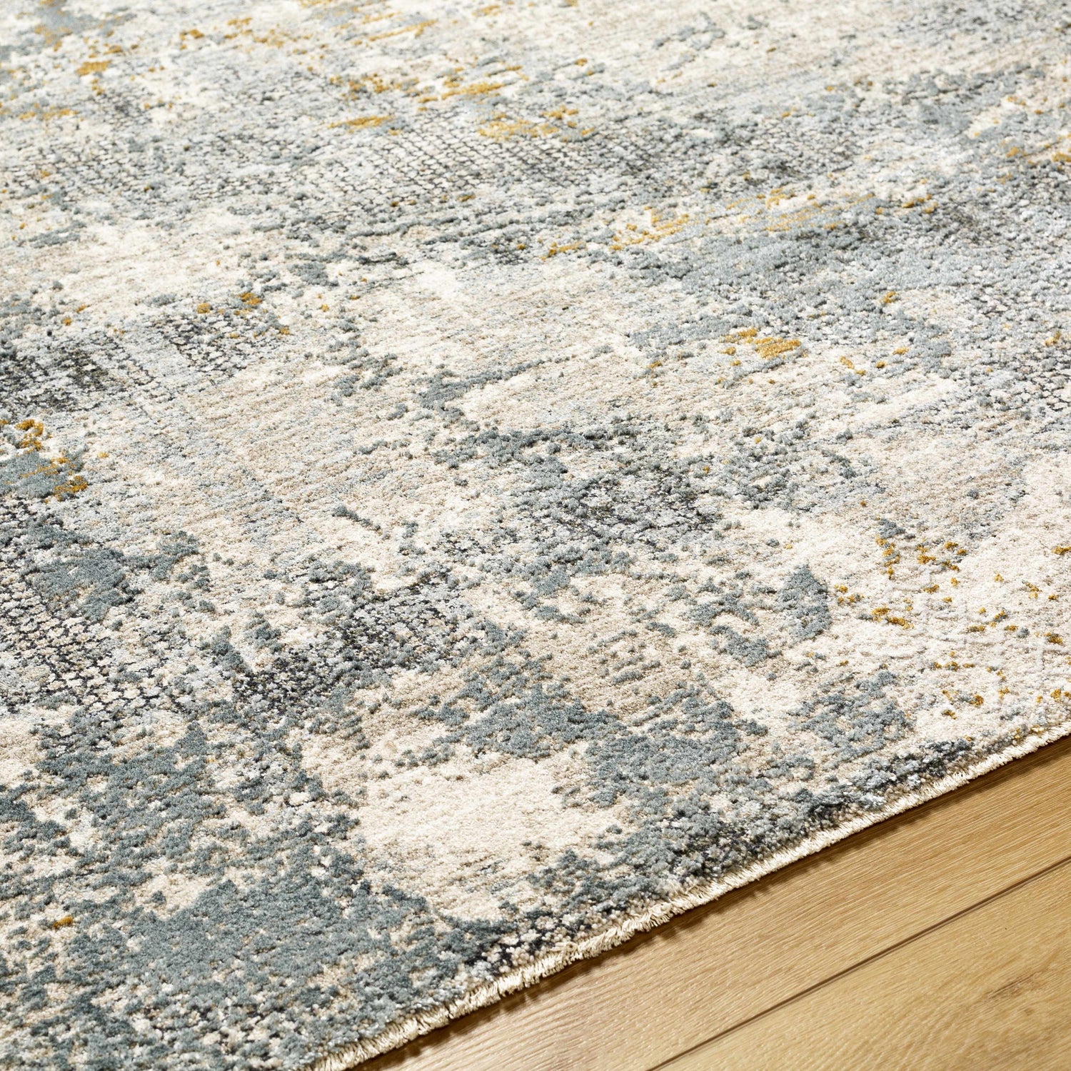 Close-up of the Chaya Textured Abstract Rug. Features dusty sage, ink blue, light gray, and mustard colors. Texture