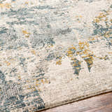 Close-up of the Chaya Textured Abstract Rug. Features dusty sage, ink blue, mustard, and off-white hues. Texture