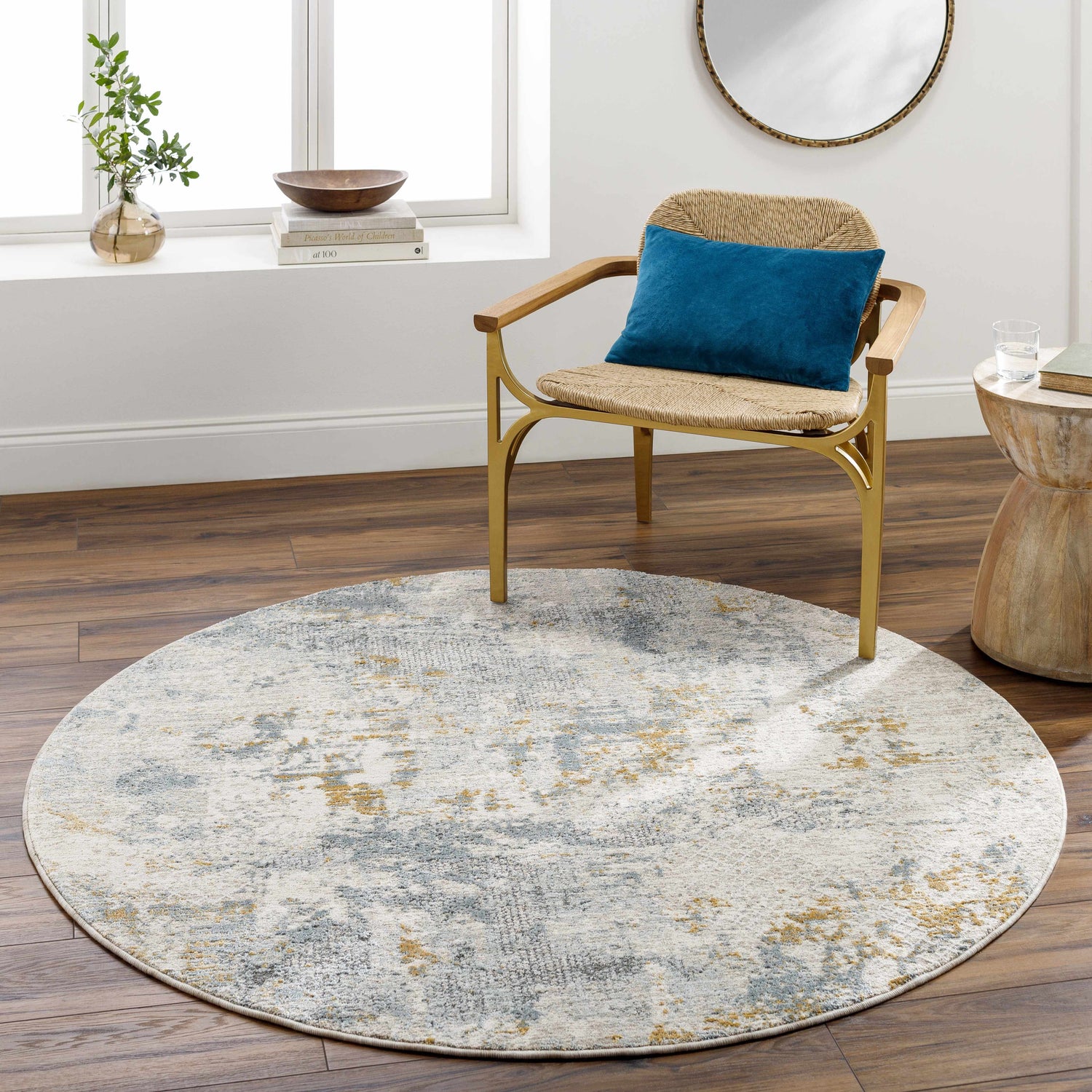 Living room scene with round Chaya Textured Abstract Rug in dusty sage, blue, gray, and mustard tones. Contemporary style. Roomscene-Round