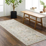 Entryway with wood floors, light wood bench, and a neutral Emile Textured Rug with Fringes. Roomscene-Runner
