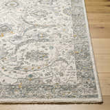 Close up of Gauge Cream & Gray Blue Rug. Traditional floral pattern in cream, gray, and blue on wood floor. Front