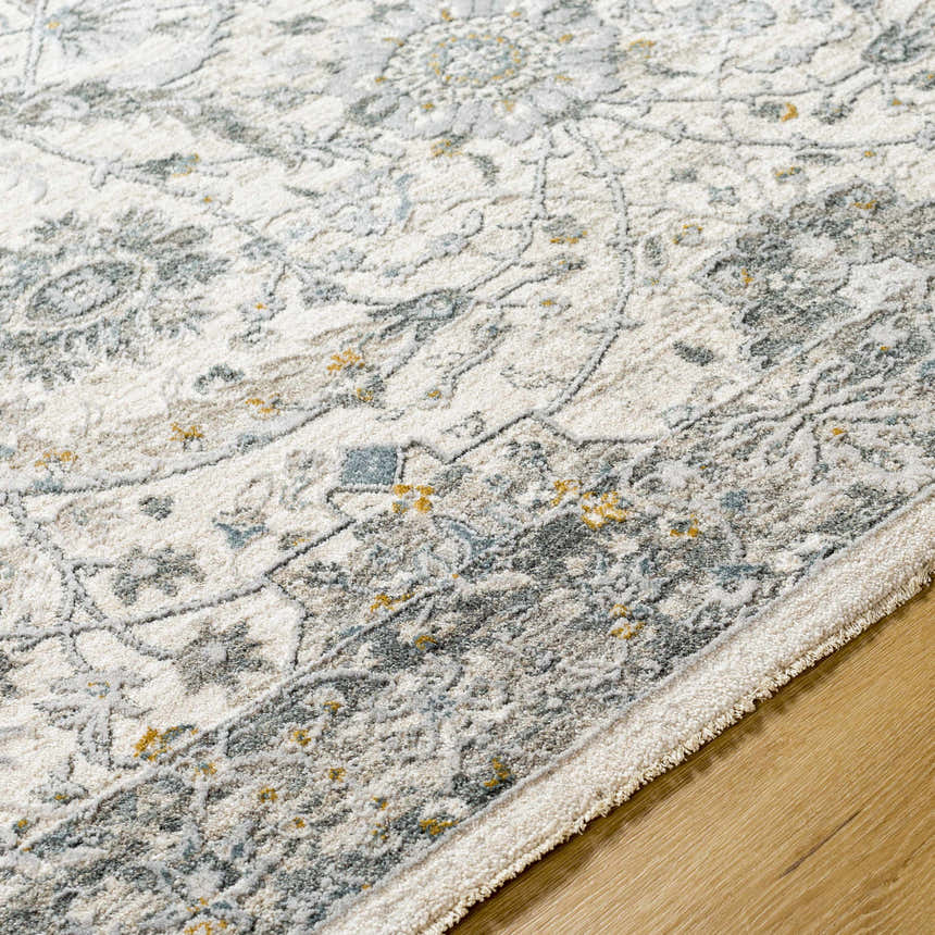 Close-up of the Gauge Cream & Gray Blue Rug, showing its traditional floral pattern and soft, textured weave. Texture