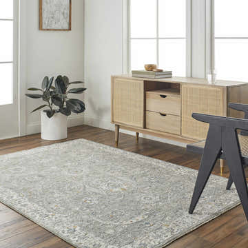 Living room scene with Gauge Gray Blue Textured Rug, wood floors, and a light wood cabinet. Roomscene-Rectangle