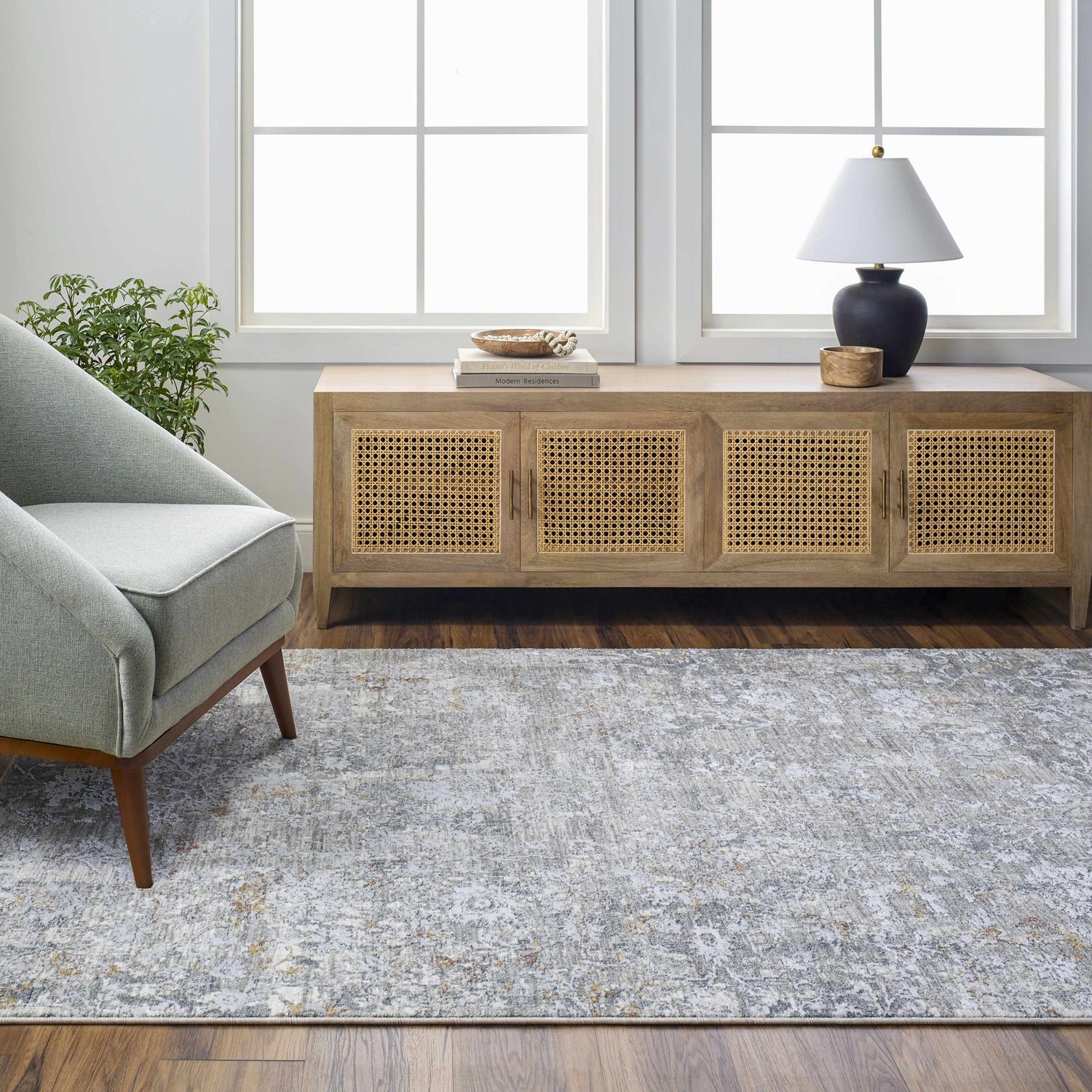 Living room scene with gray Ifama Textured Rug, light wood cabinet, and gray chair. Roomscene-Rectangle