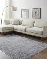 Living room scene with a neutral sofa and the gray Ifama Textured Rug. Roomscene-Rectangle