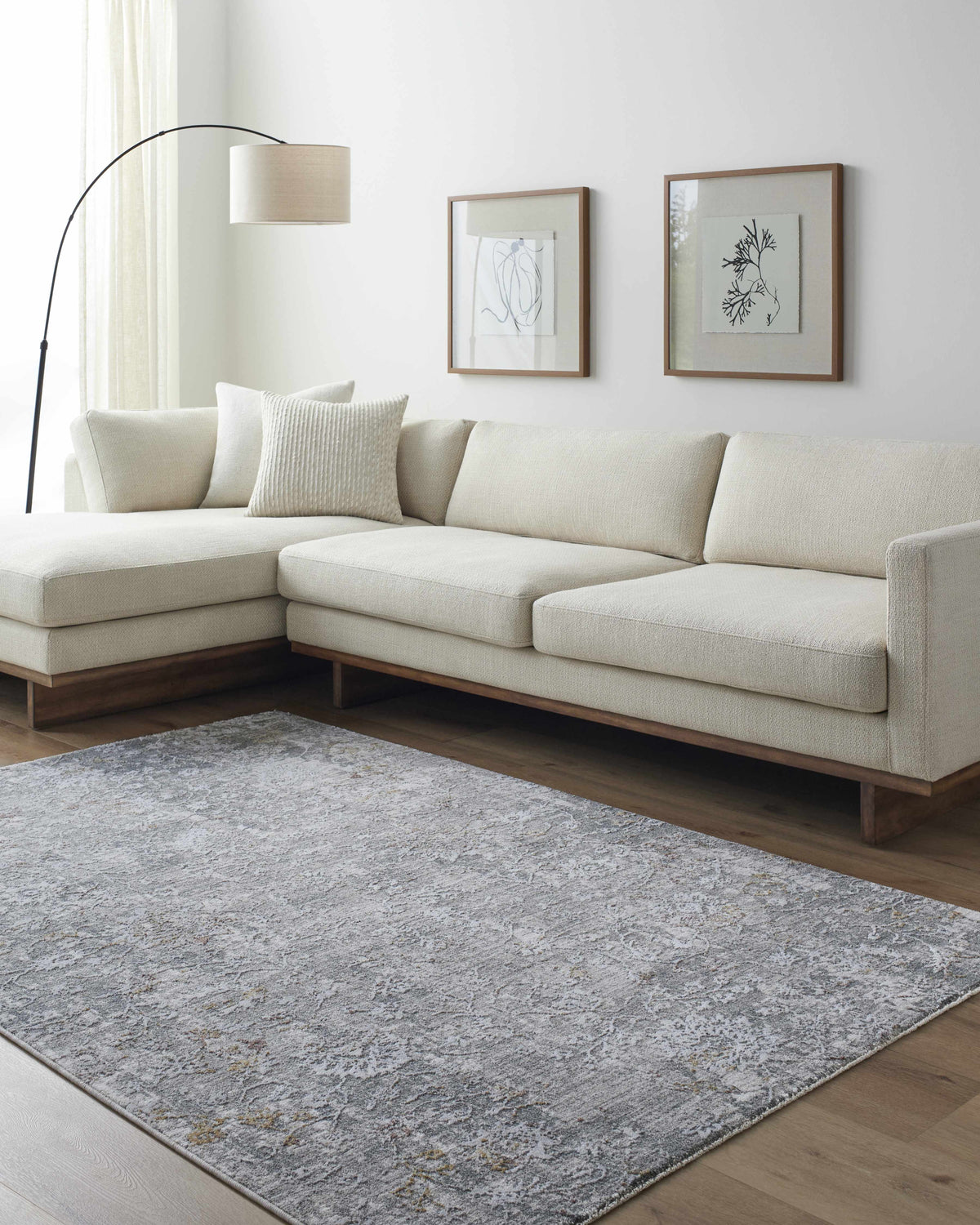 Living room scene with a neutral sofa and the gray Ifama Textured Rug. Roomscene-Rectangle